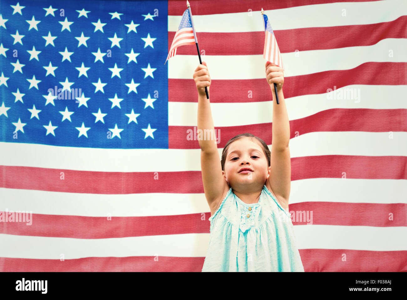 Composite image of cute girl with american flag Stock Photo