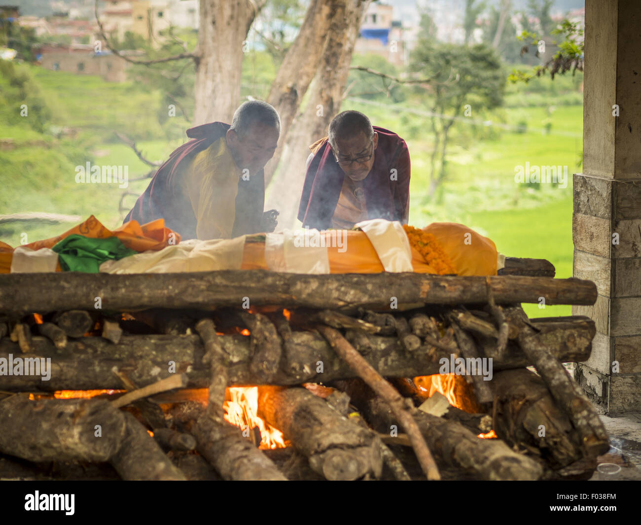 Nepal. 5th Aug, 2015. Buddhist monk light a funeral pyre at a cremation
