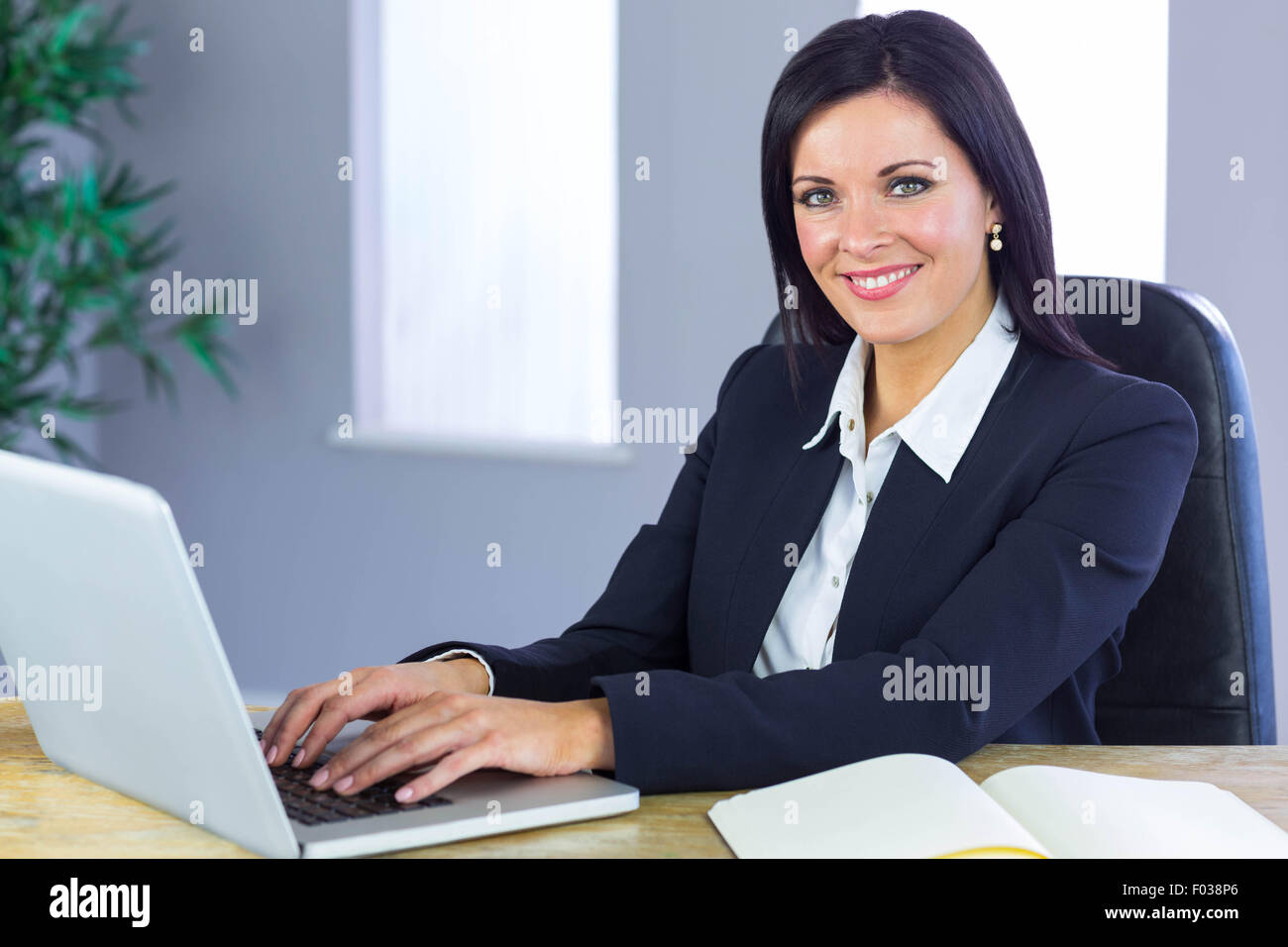 Happy businesswoman working at her desk Stock Photo - Alamy