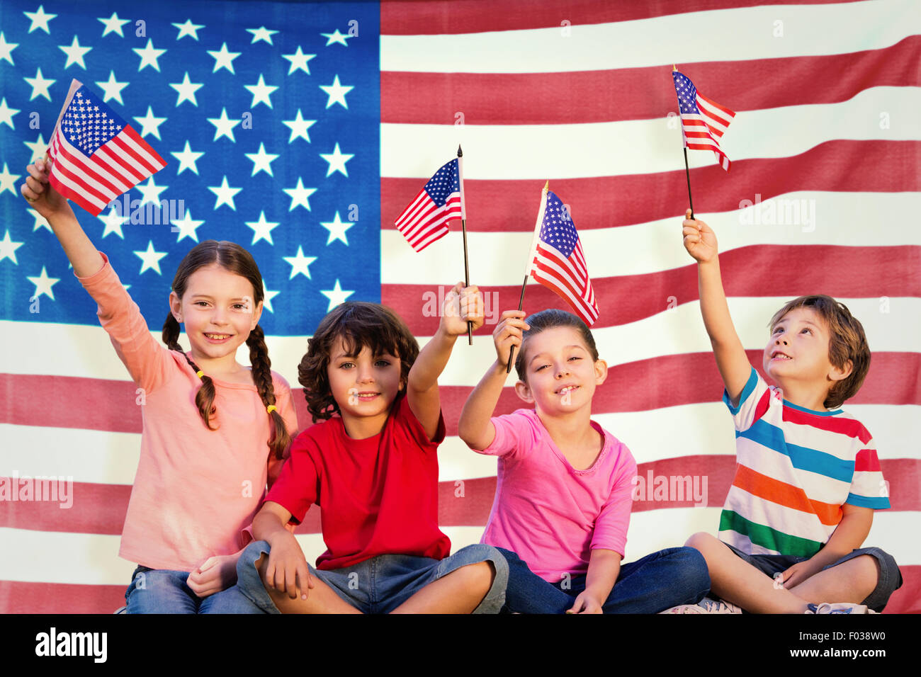 Composite image of children with american flags Stock Photo