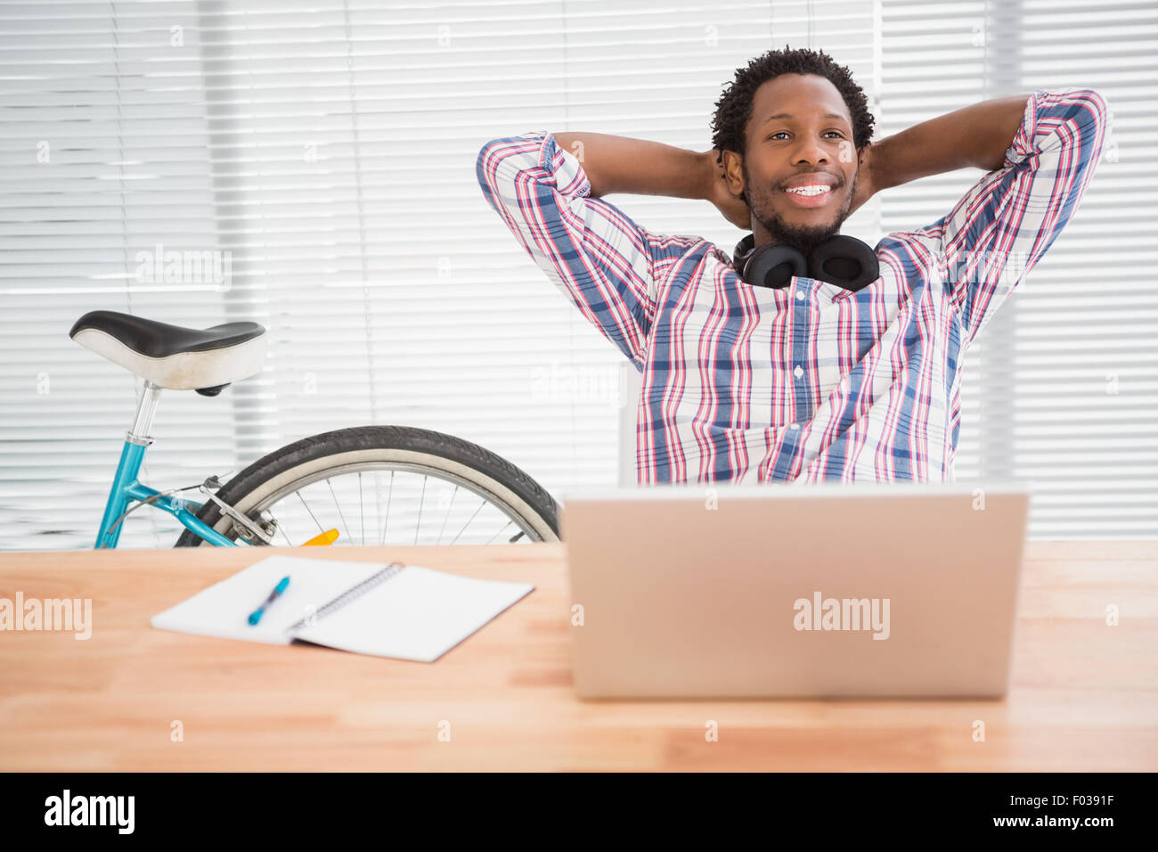 Young businessman relaxes at his place in the office Stock Photo