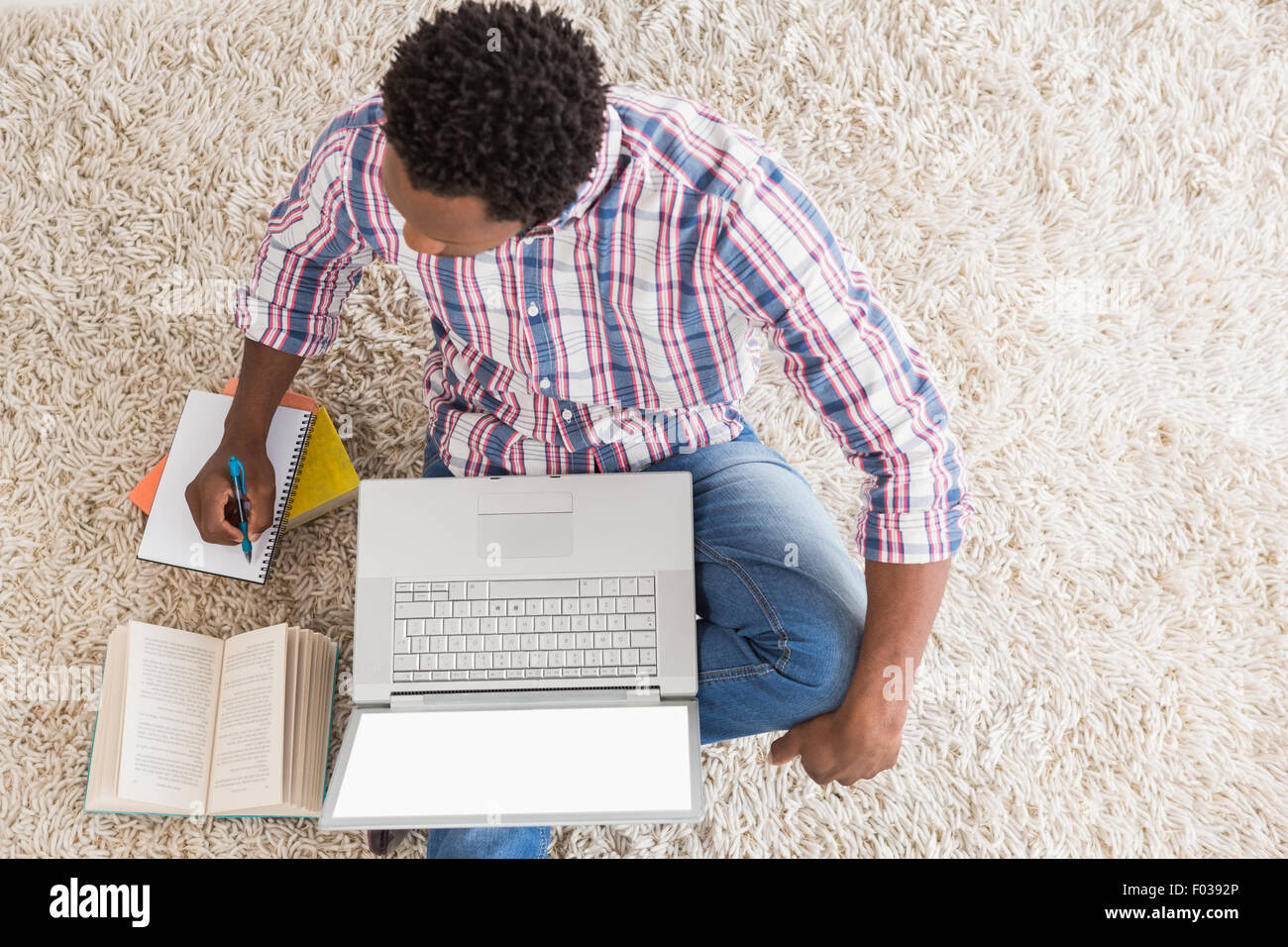 Young businessman writing on paper in the office Stock Photo - Alamy