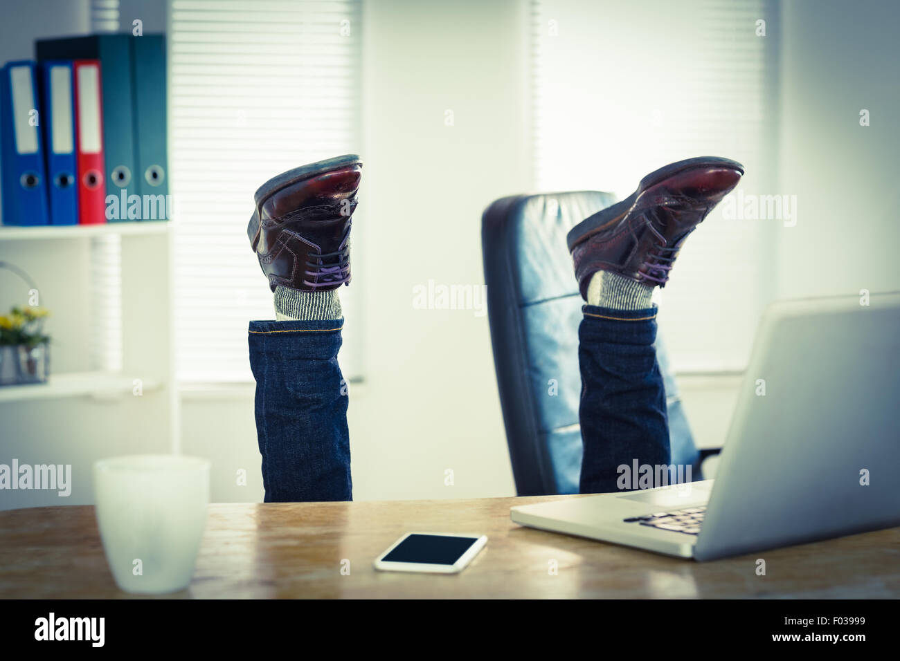 Businessman upside down at his desk Stock Photo Alamy