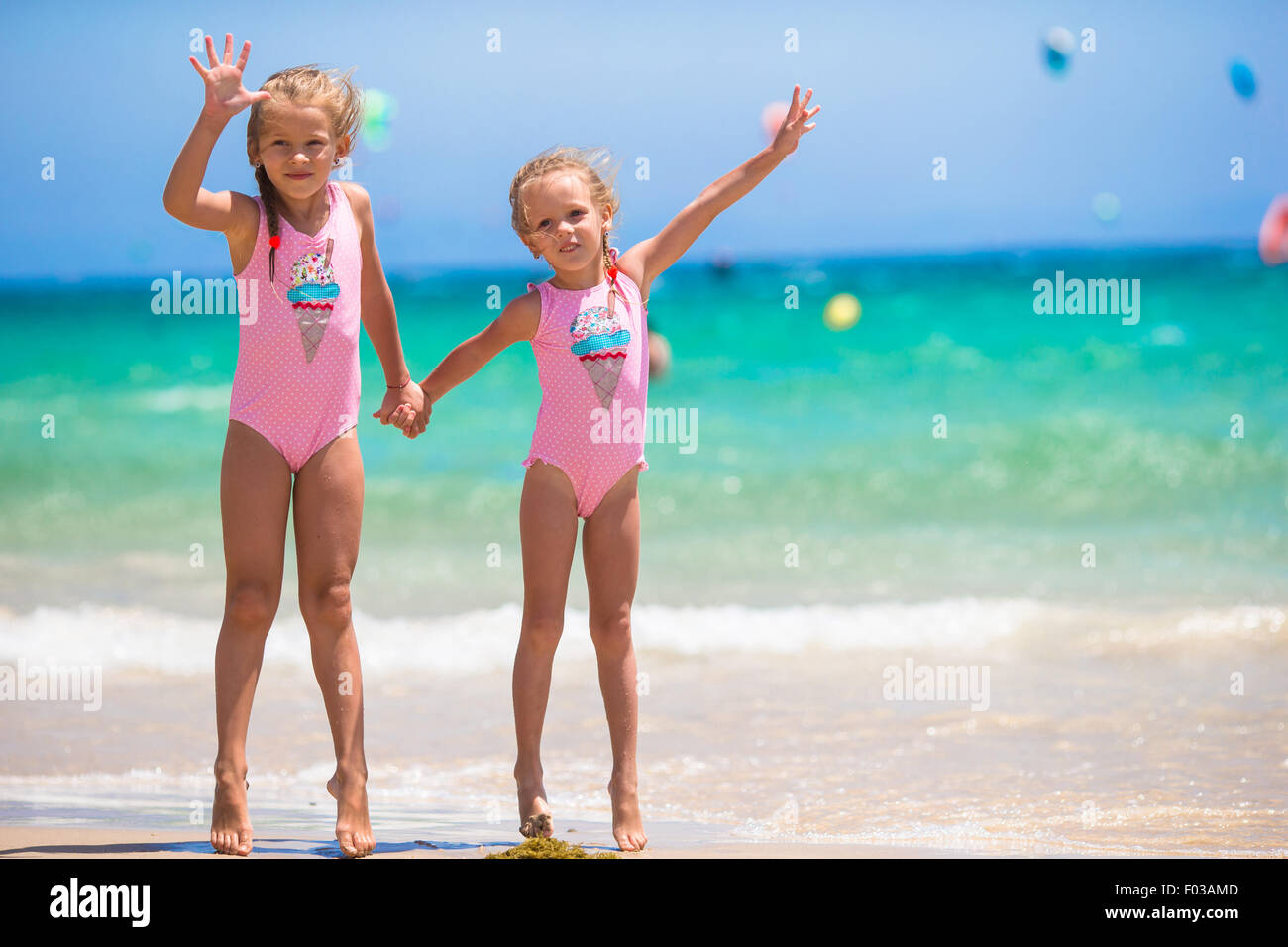 Adorable little girls having fun during beach vacation Stock Photo - Alamy