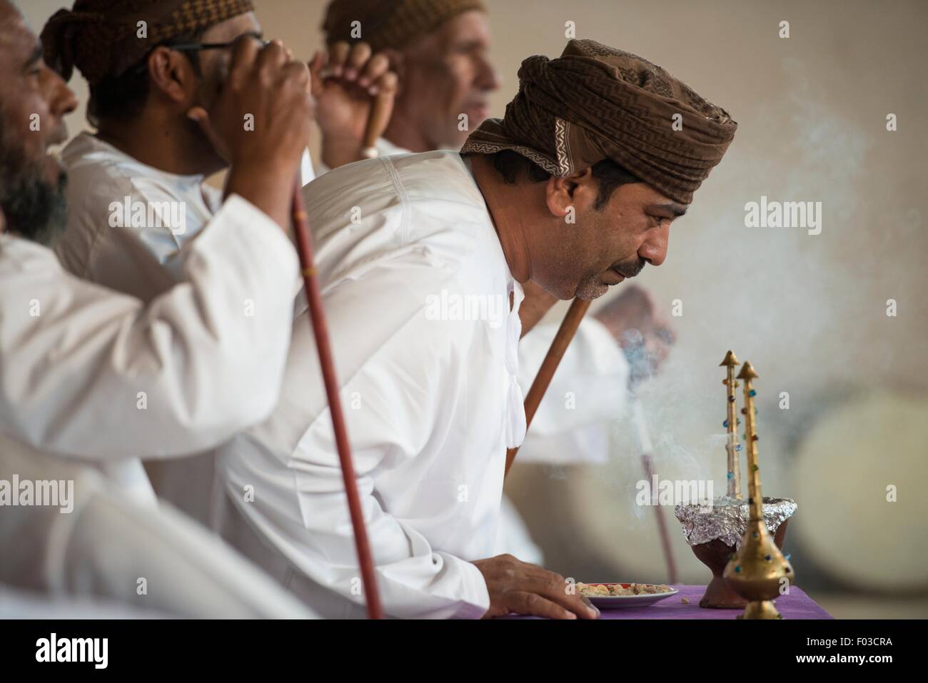 Men performing a ritual at a festival outside of Muscat, Oman. Stock Photo