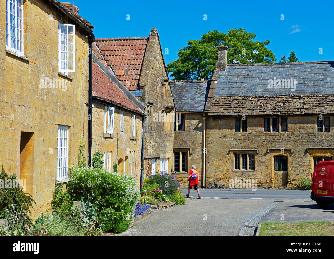 Postman delivering letters to cottages in the village of Montacute, Somerset, England UK Stock Photo