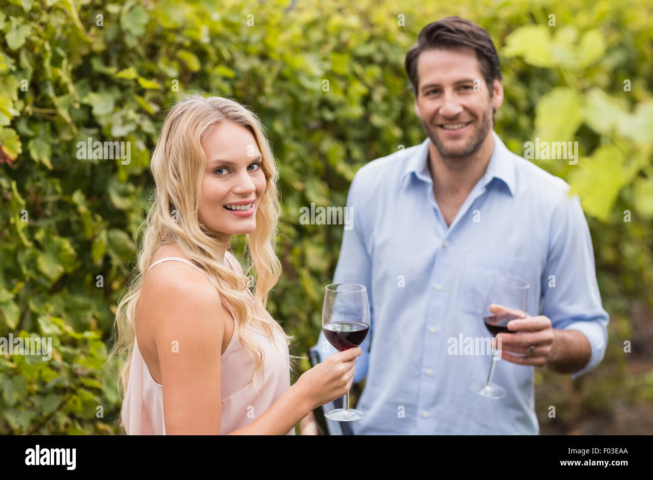 Young happy couple smiling at camera Stock Photo - Alamy