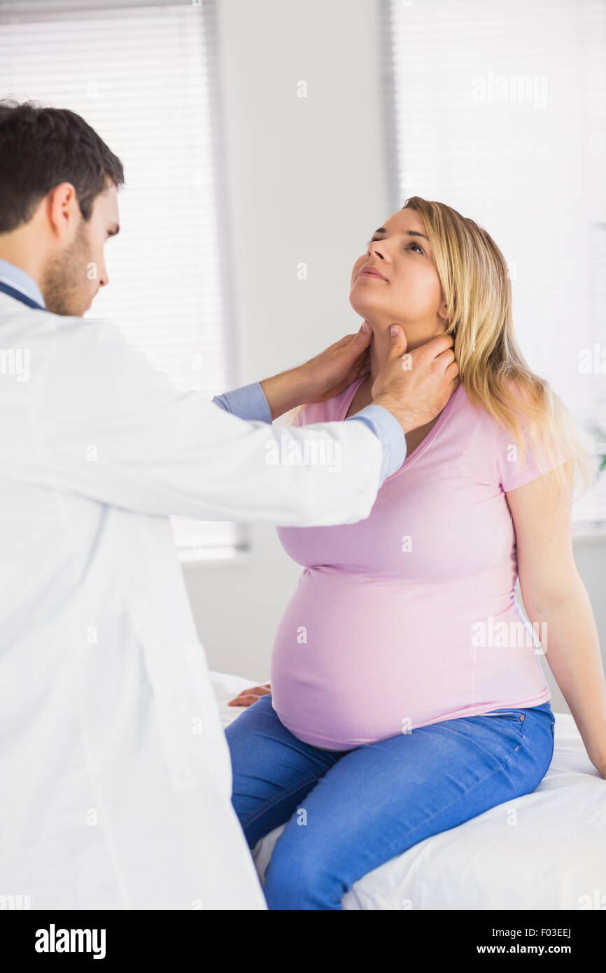 Doctor examining neck of pregnant patient Stock Photo Alamy