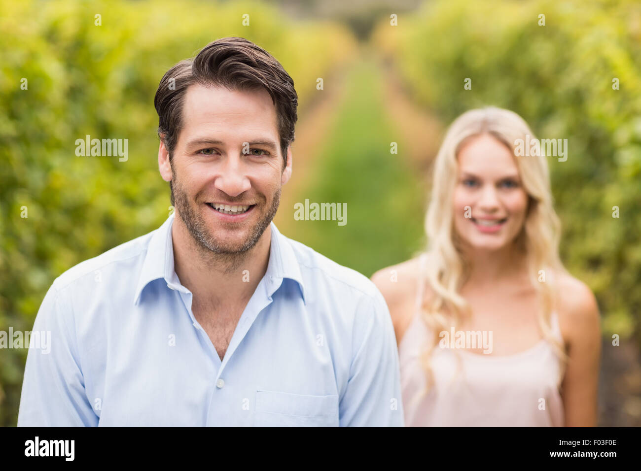 Young happy couple smiling at camera Stock Photo - Alamy