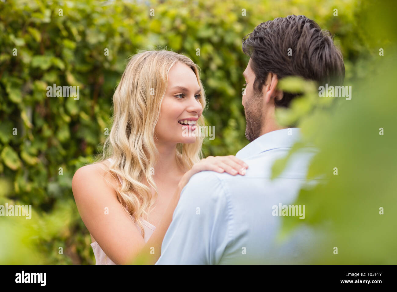 Young happy couple smiling at each other Stock Photo - Alamy