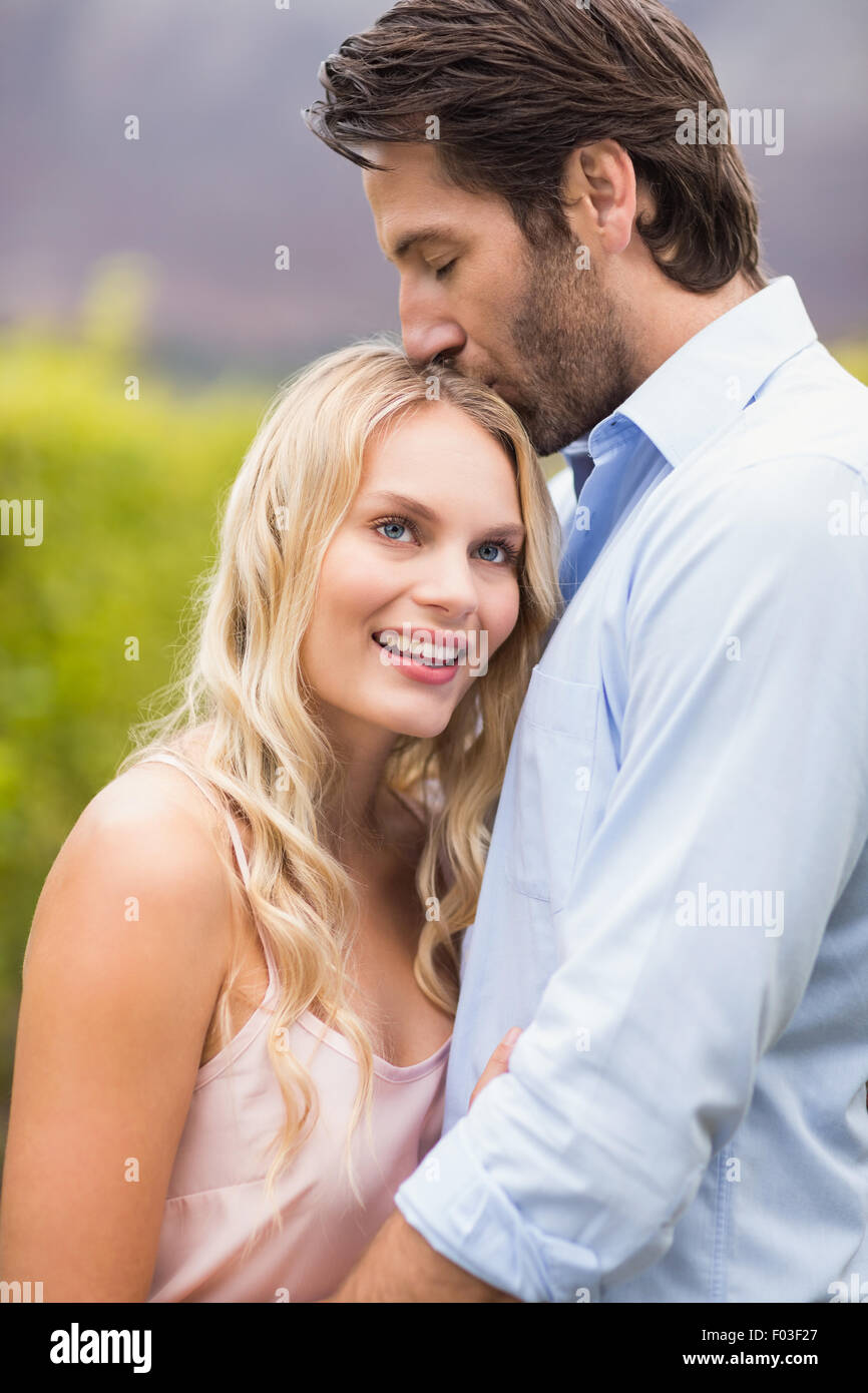Young happy man kissing woman on the forehead Stock Photo - Alamy