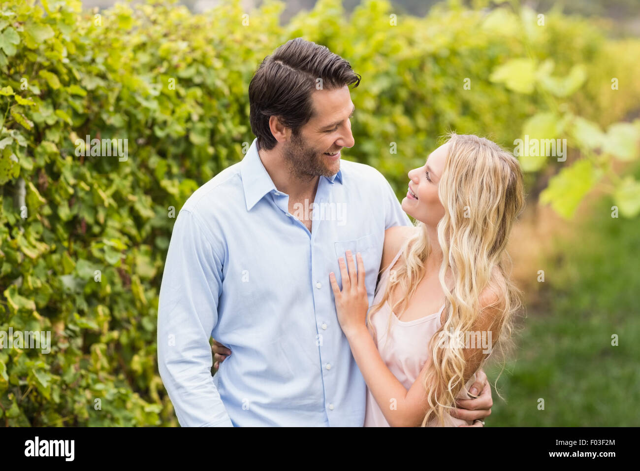 Young happy couple smiling at each other Stock Photo - Alamy