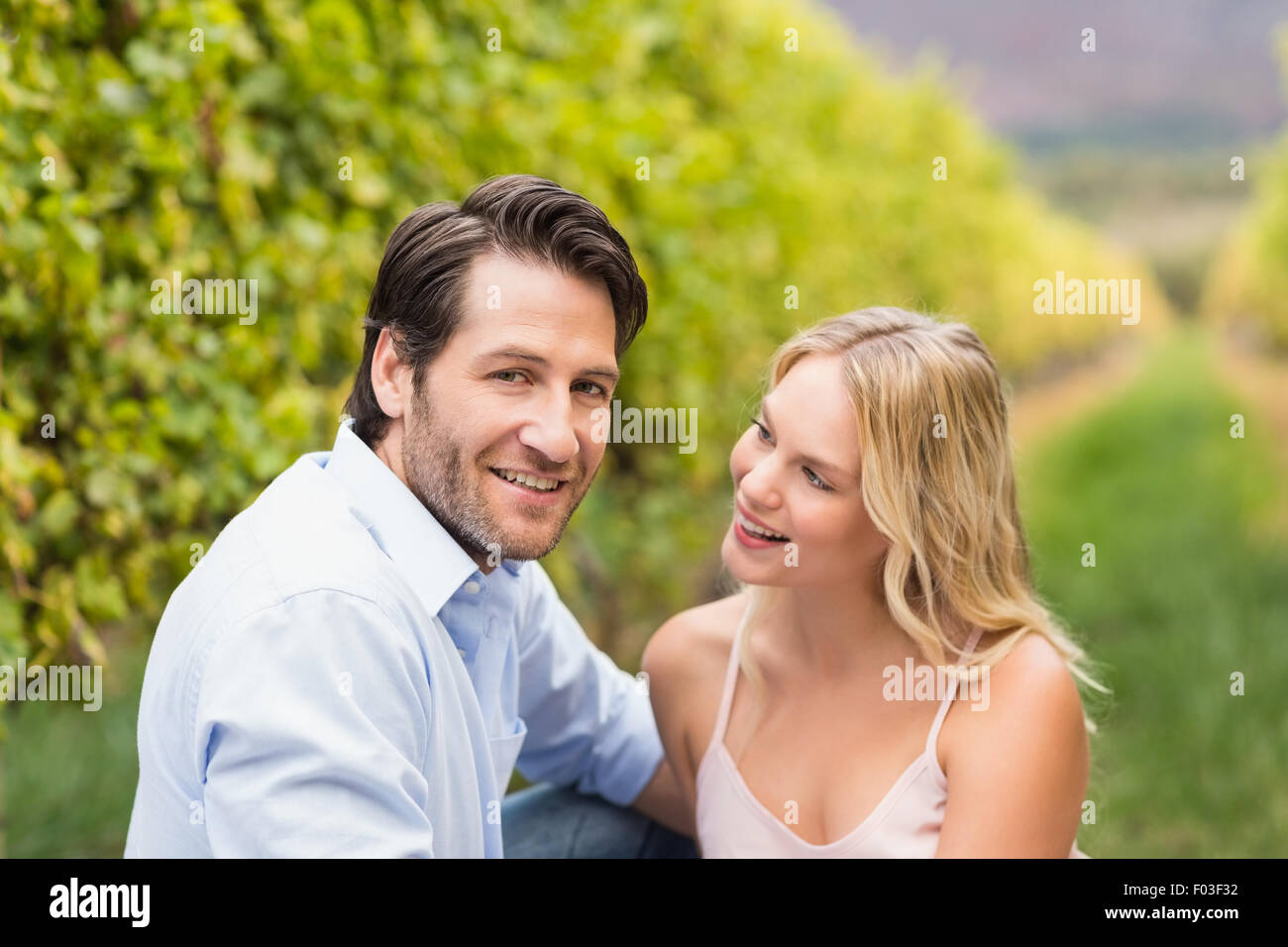 Young happy couple smiling at camera Stock Photo - Alamy