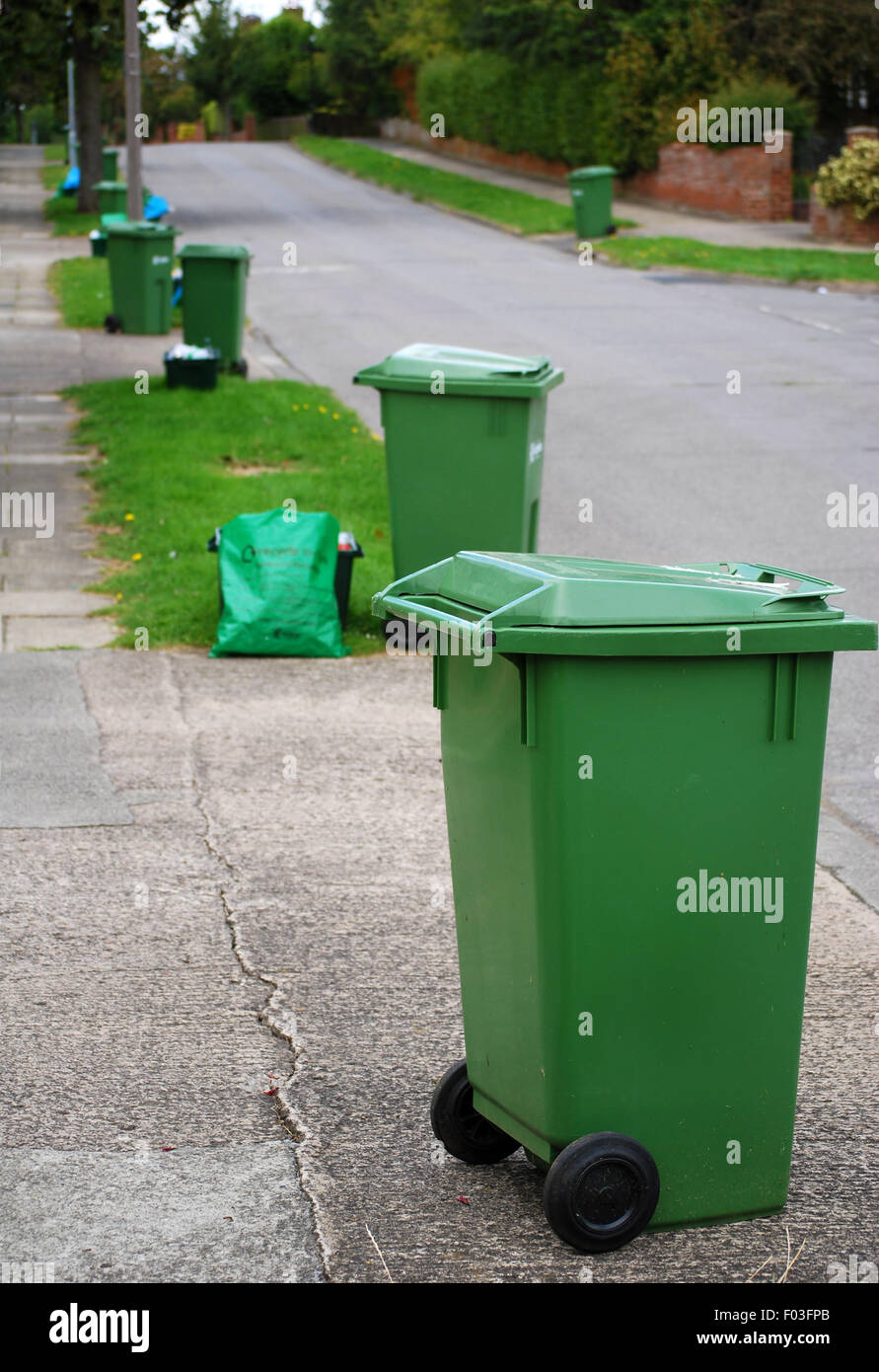 Urban neighbourhood green bin recycling collection scene Stock Photo
