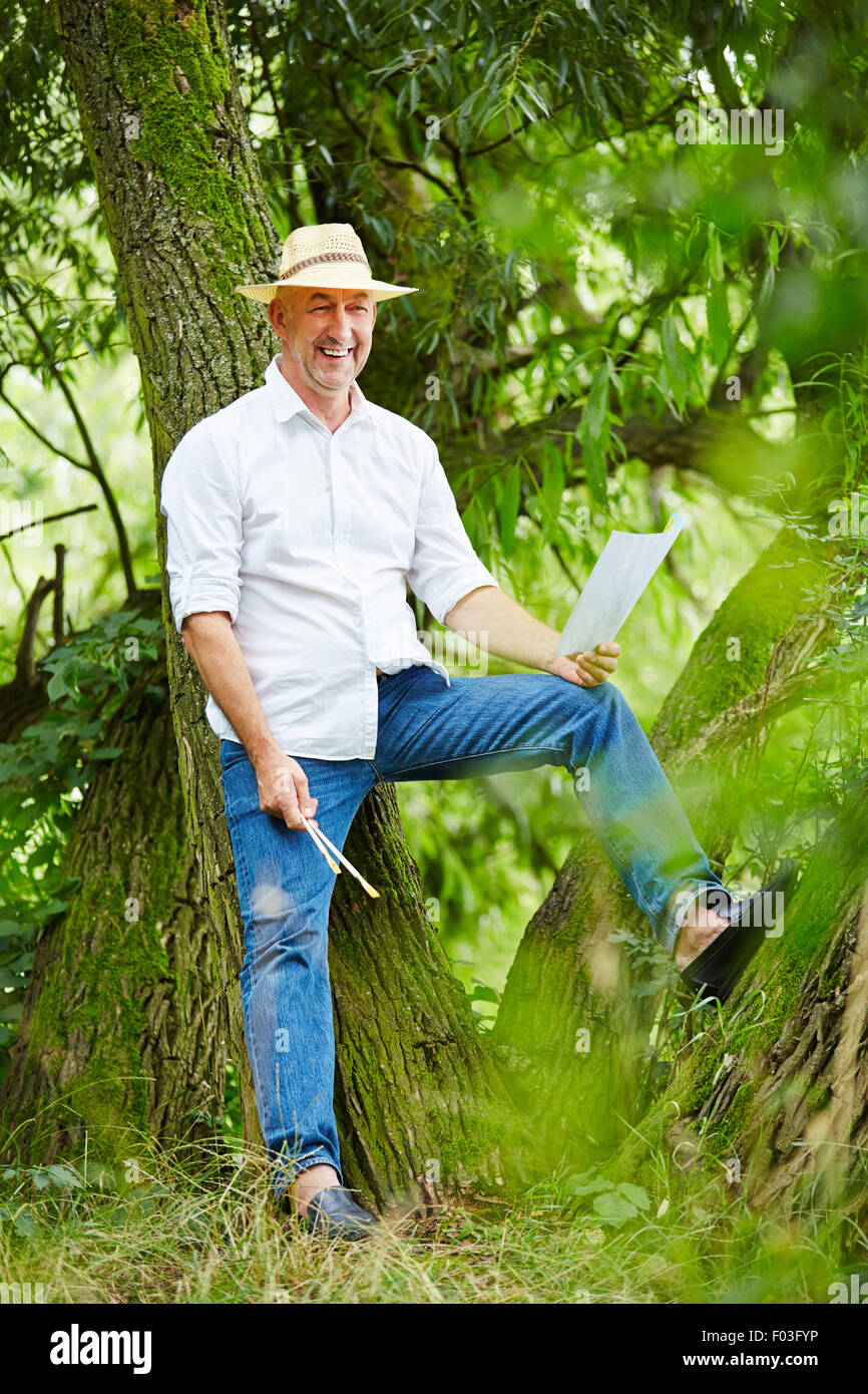 Senior man leaning on garden hi-res stock photography and images - Alamy