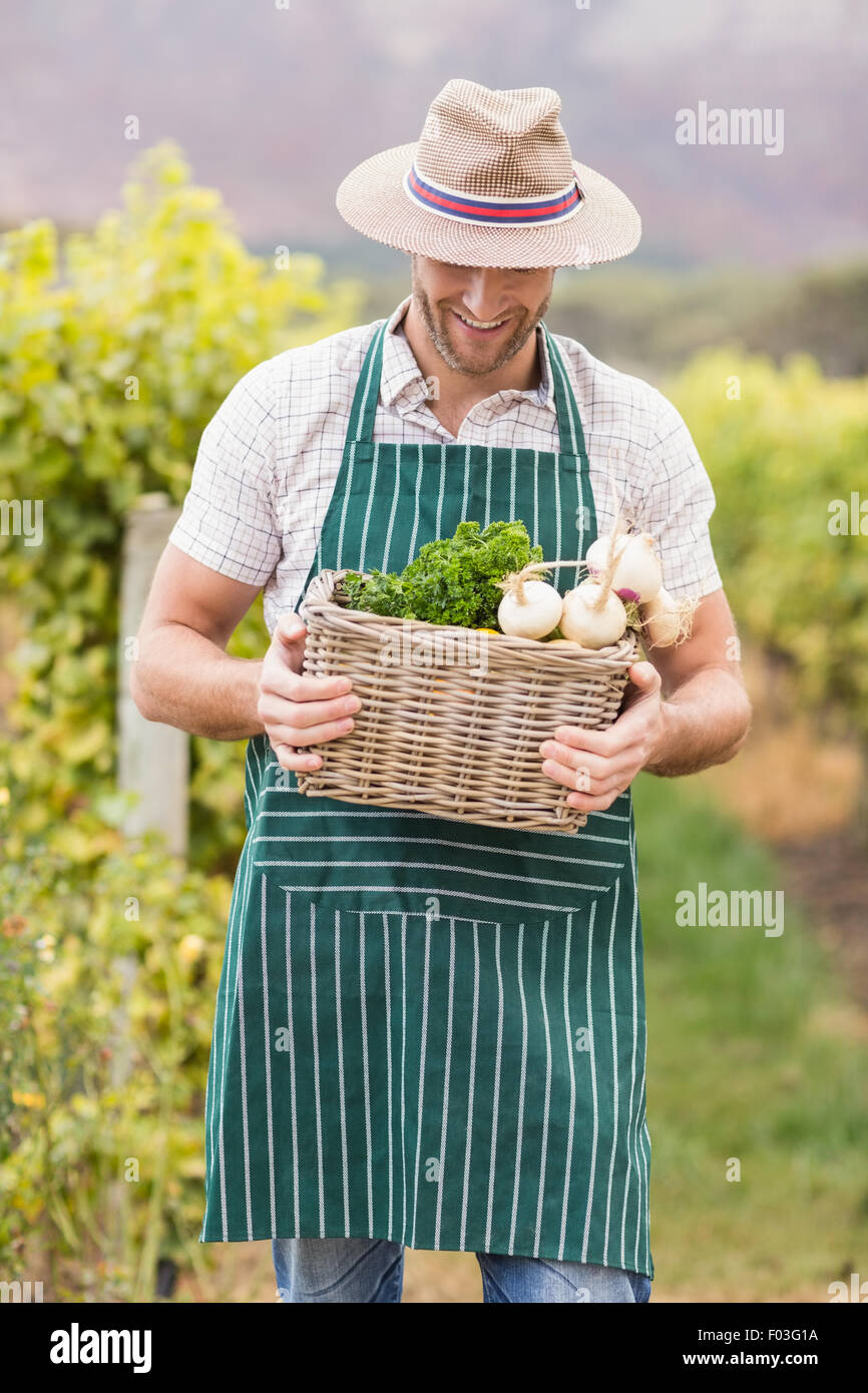 Young happy farmer holding a basket of vegetables Stock Photo - Alamy
