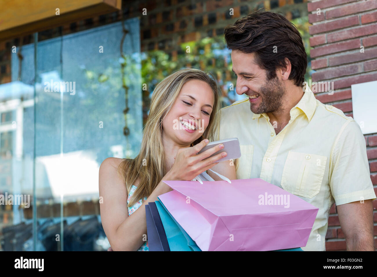 Laughing couple using smartphone Stock Photo