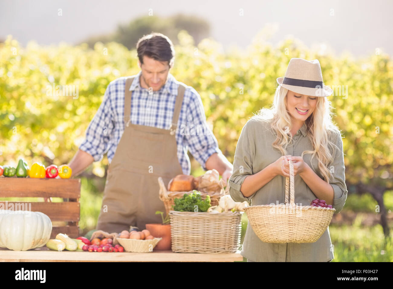Blonde customer holding a vegetables basket Stock Photo - Alamy