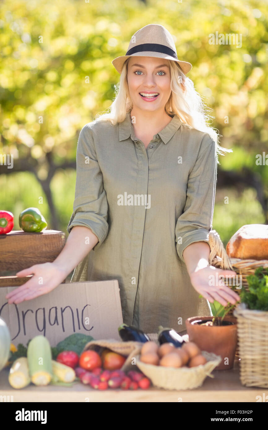 Smiling blonde presenting the table of local food Stock Photo