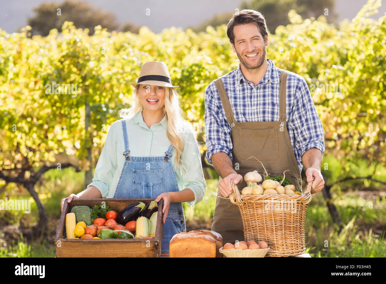 Happy farmer couple presenting their local food Stock Photo