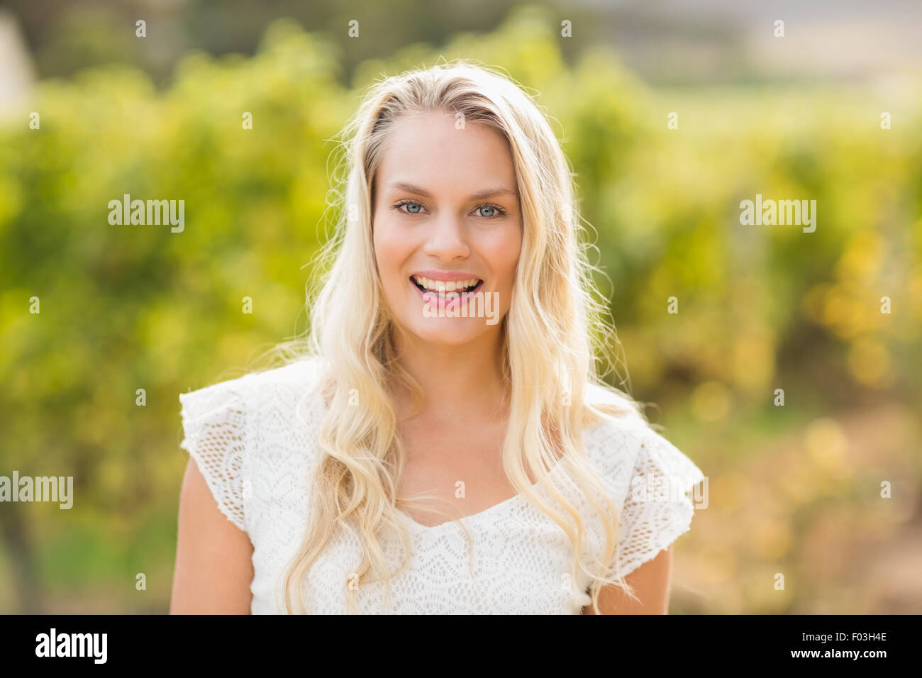 Pretty blonde woman looking at the camera Stock Photo - Alamy
