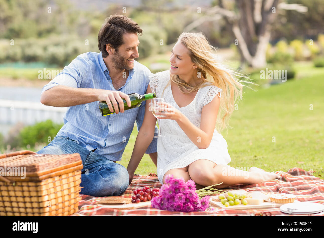 Cute couple on date pouring wine in a glass Stock Photo