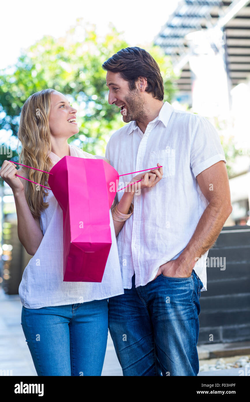 Smiling couple with shopping bags laughing Stock Photo
