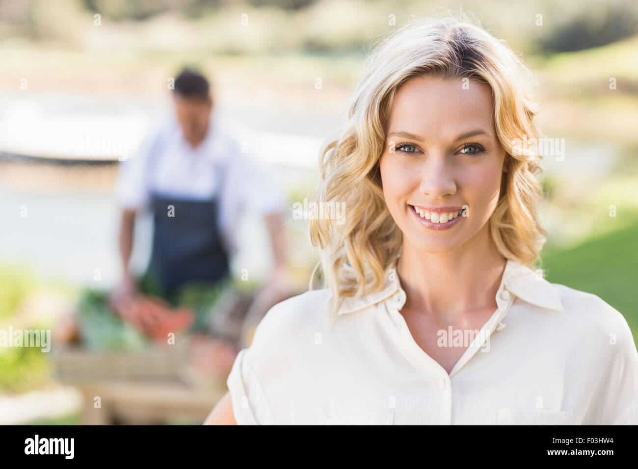 Smiling blonde woman looking at the camera Stock Photo - Alamy