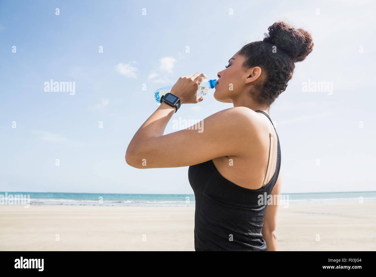 Fit woman drinking water from bottle Stock Photo
