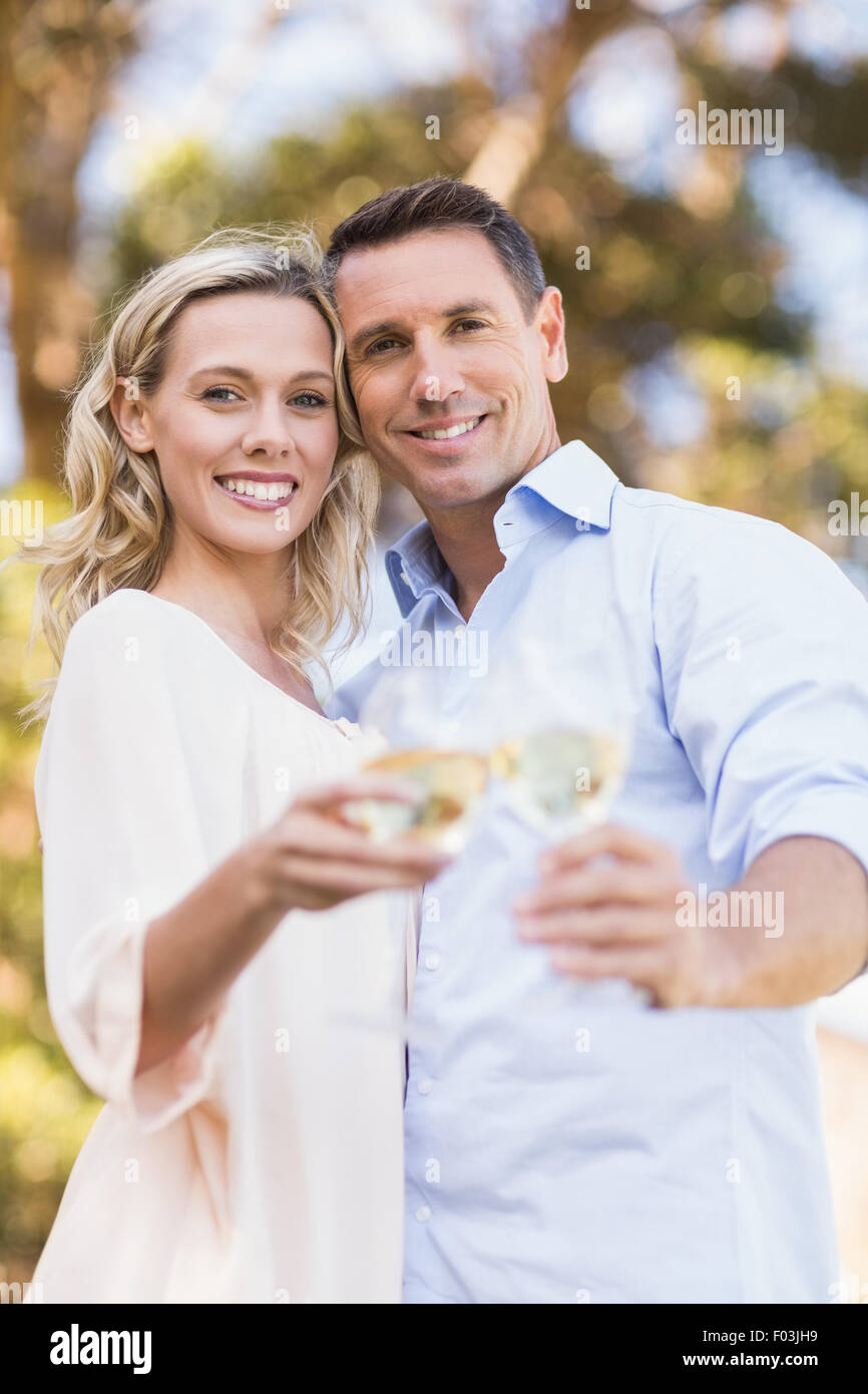 Portrait of smiling couple embracing and toasting with wineglass Stock Photo