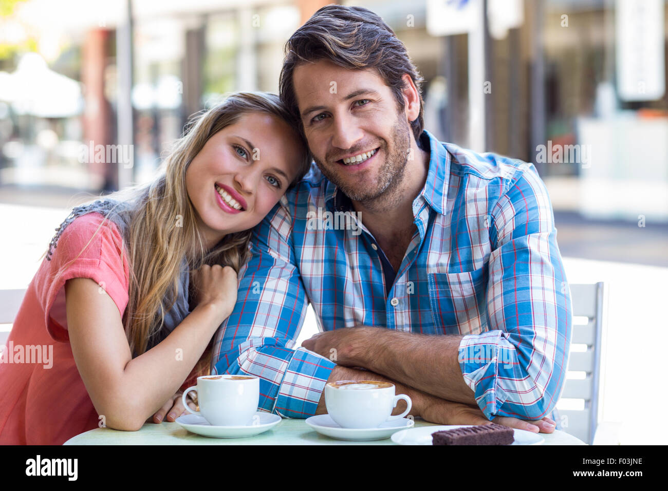 Smiling couple having tea in a cafe Stock Photo