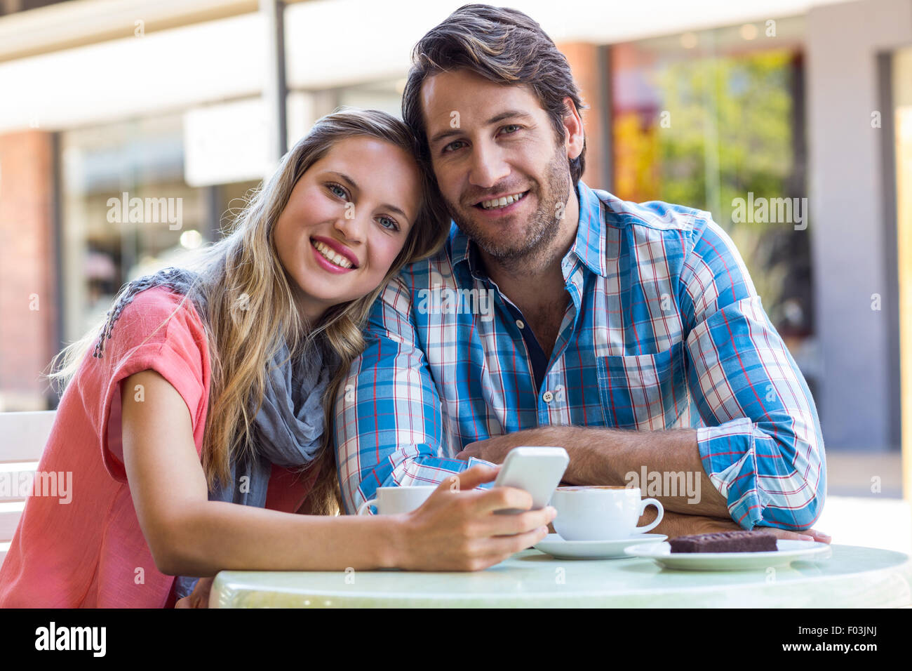 Smiling couple having tea in a cafe Stock Photo