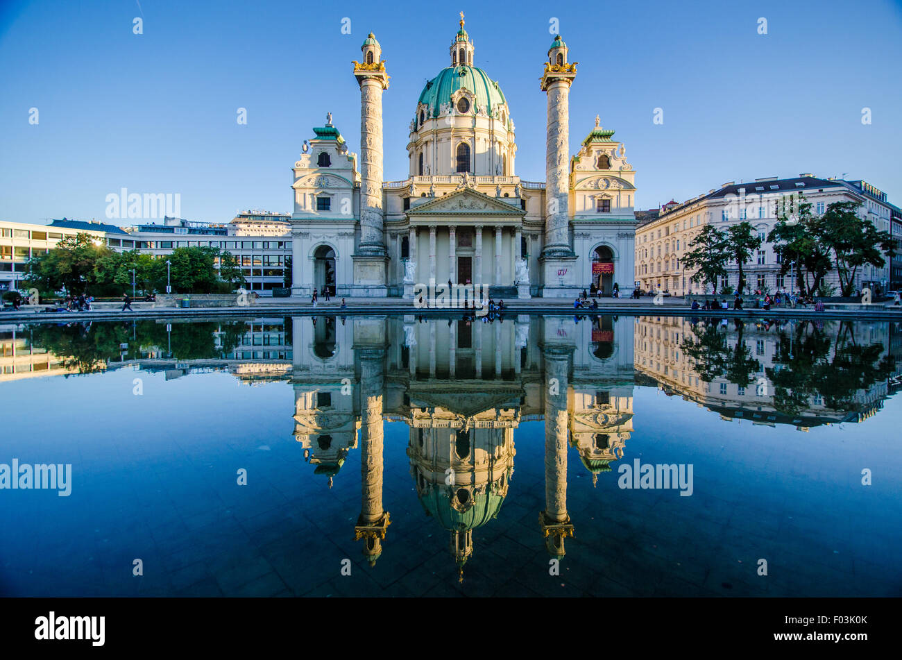 A water reflection of Karskirche in Vienna during sunset light. Stock Photo