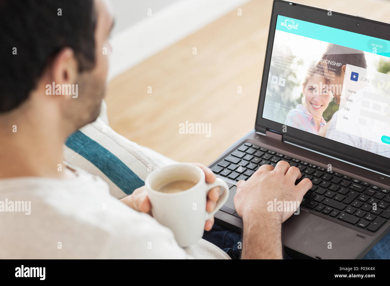 Composite image of man using laptop Stock Photo