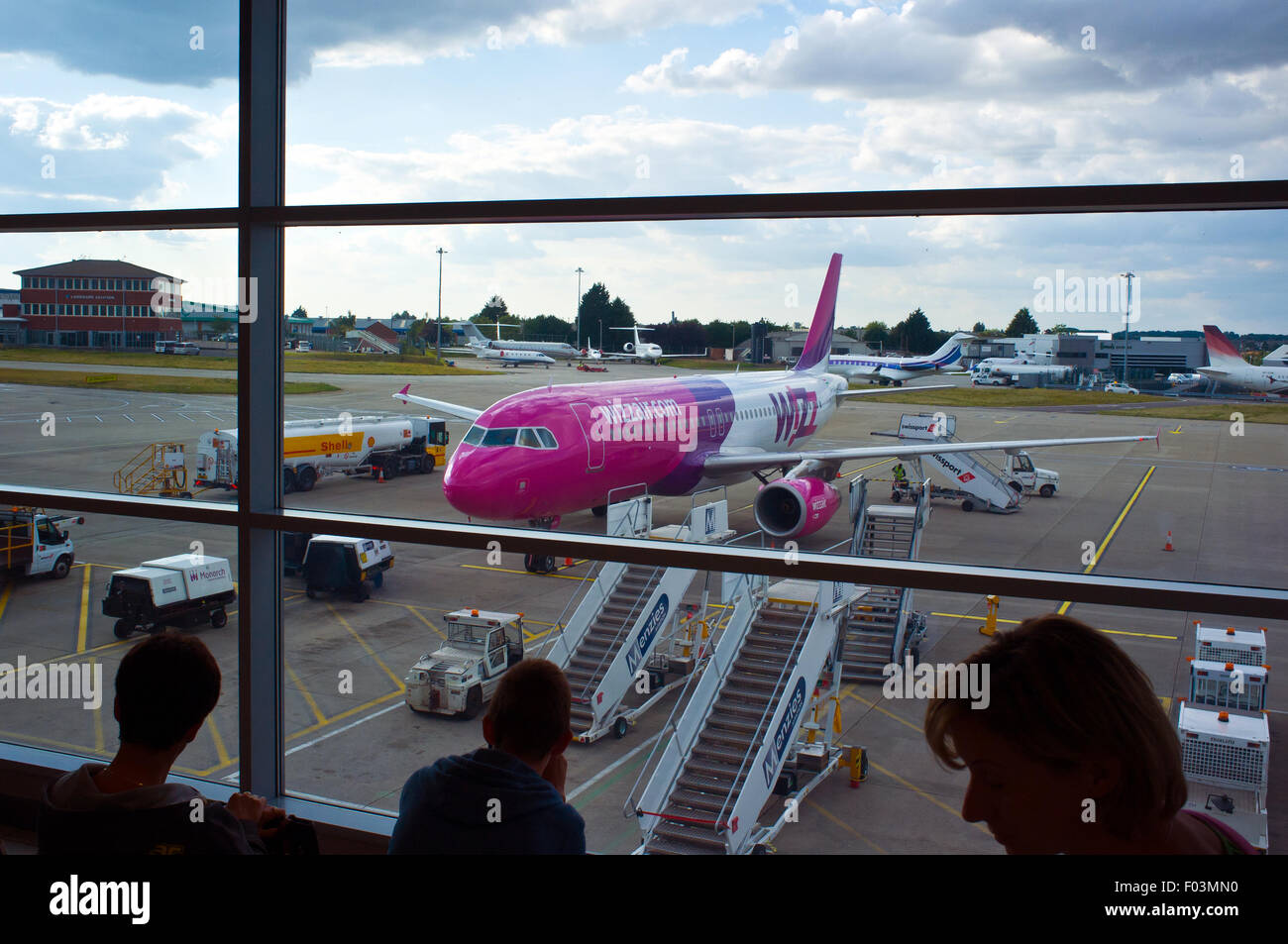 Passengers awaiting to board a Wizz Air flight to Budapest from Luton Stock Photo