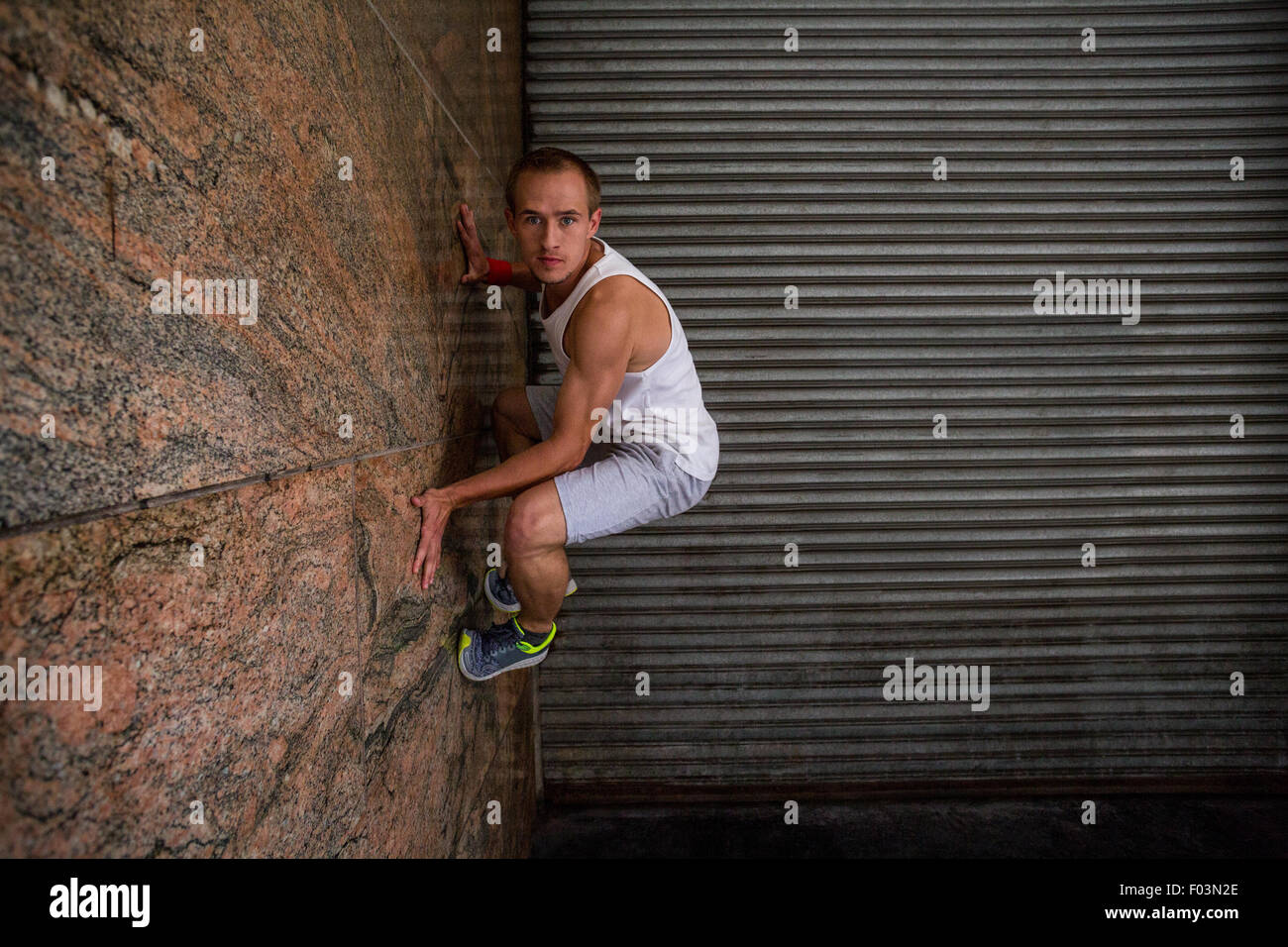 Extreme athlete gripping to wall Stock Photo