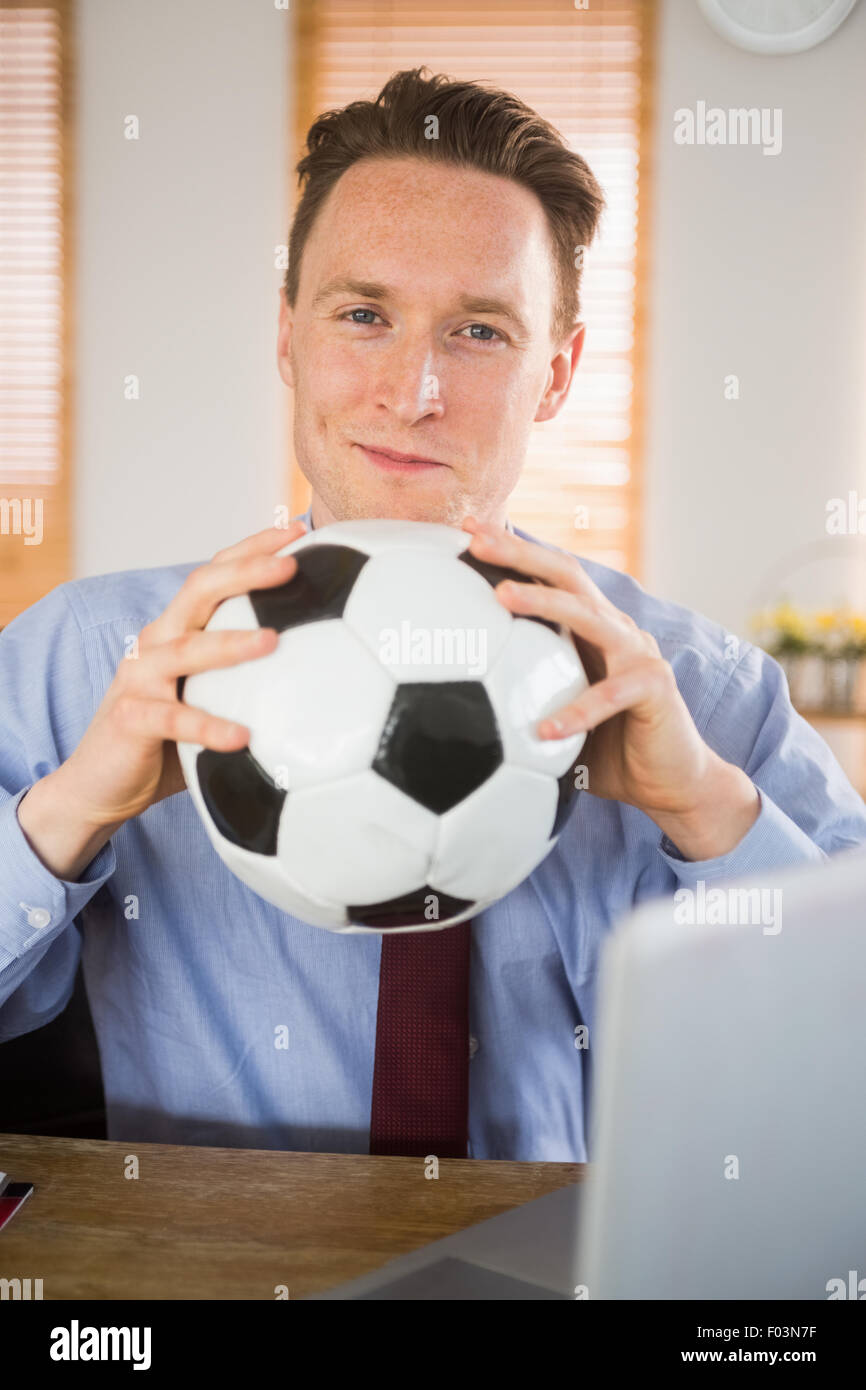 Cheerful businessman holding a soccer ball Stock Photo - Alamy
