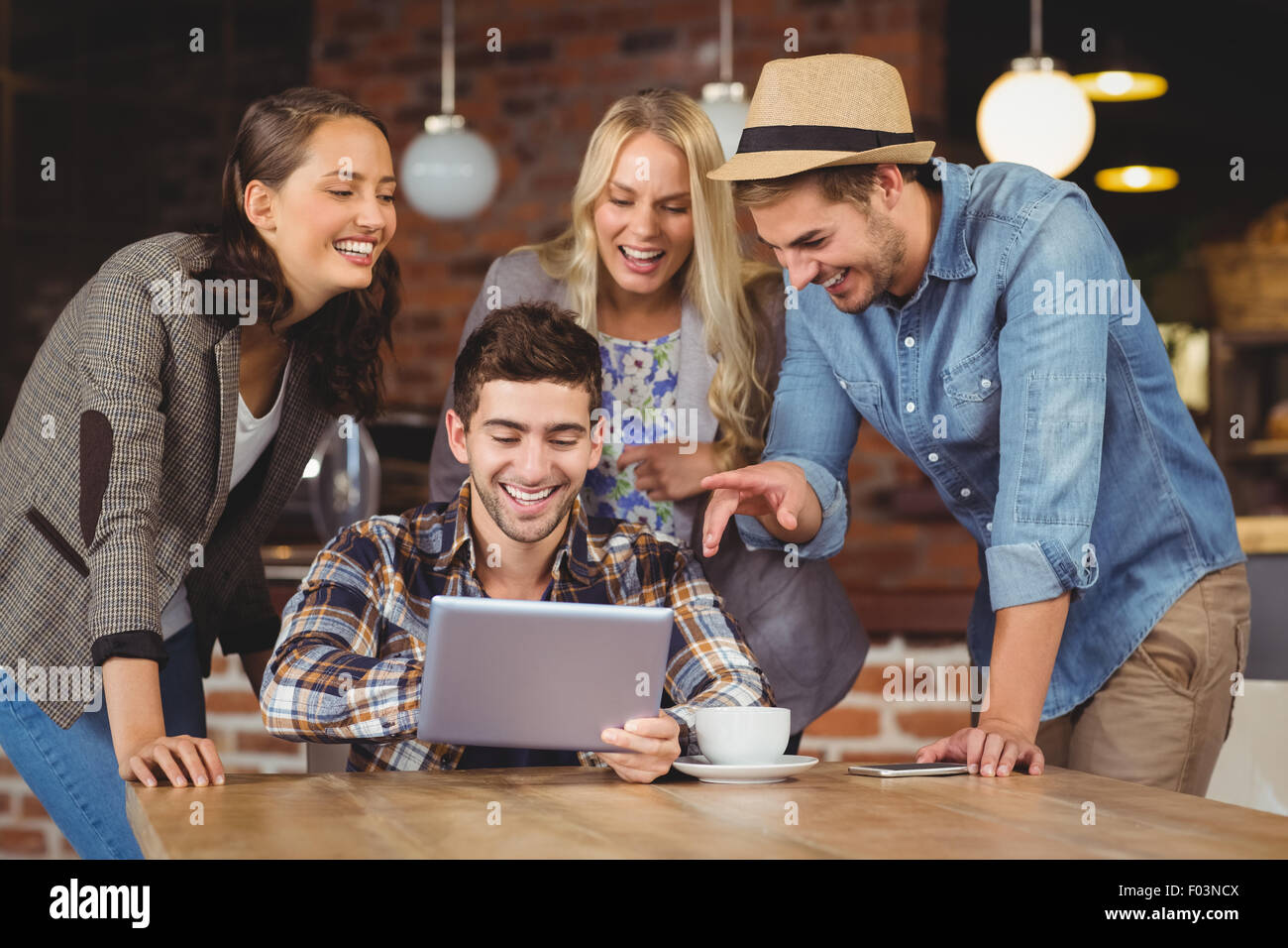 Laughing friends looking at tablet computer Stock Photo