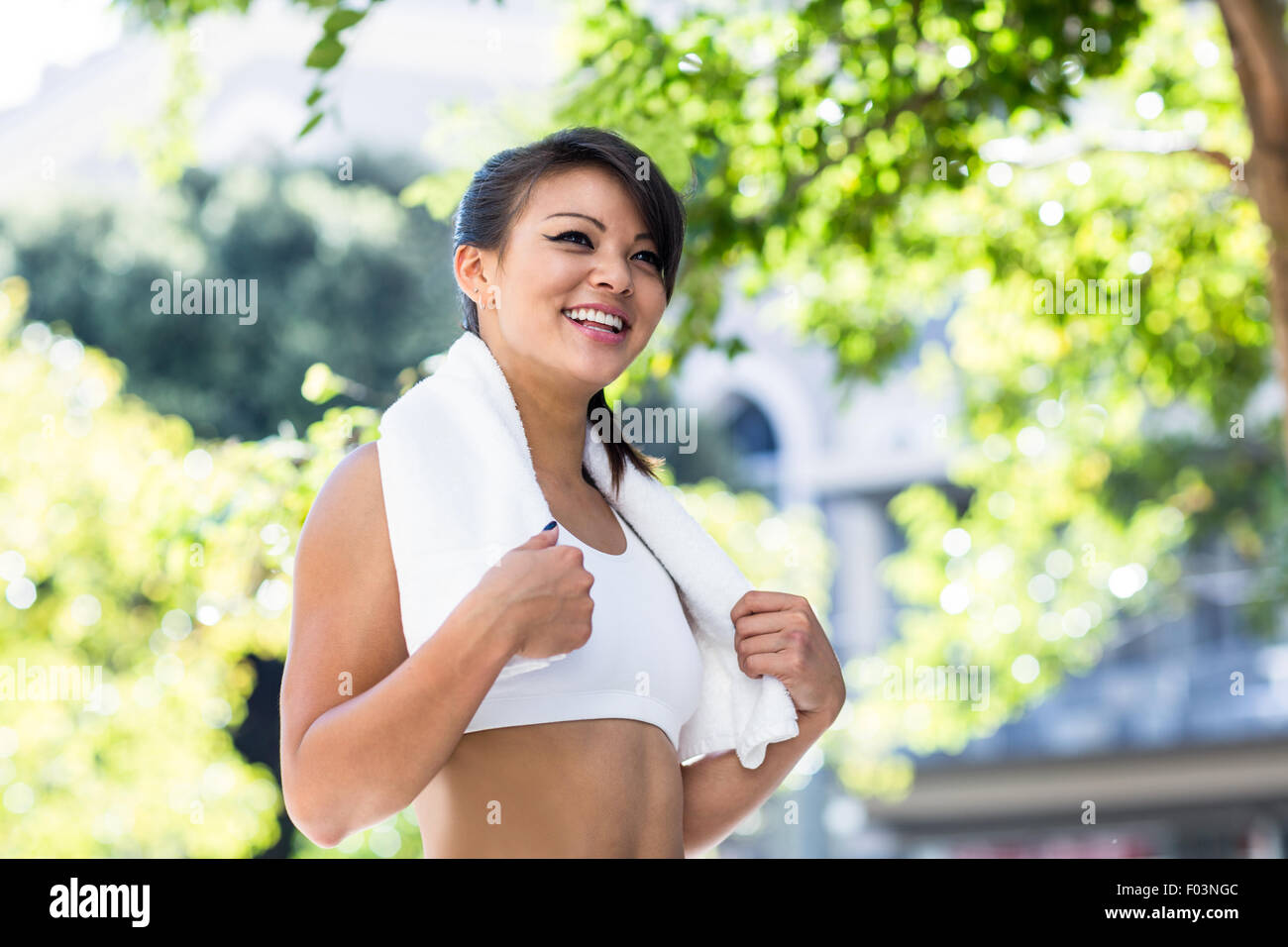 Smiling athletic woman with towel Stock Photo