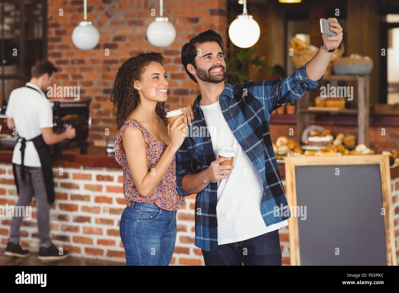 Smiling hipster couple taking selfies Stock Photo