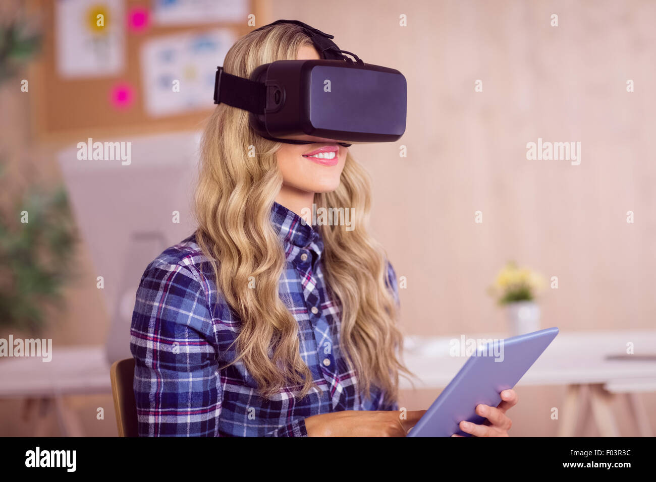 Pretty casual worker using oculus rift Stock Photo