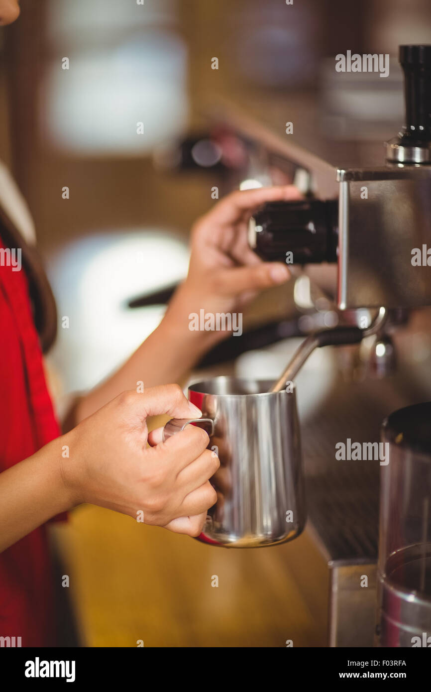 Barista steaming milk at the coffee machine Stock Photo Alamy