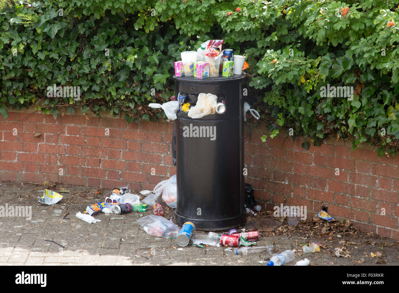 Overfull rubbish bin, England, UK Stock Photo