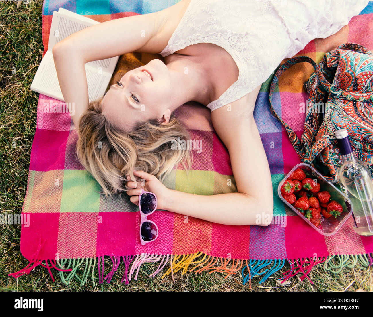 Woman lying on blanket in summer Stock Photo