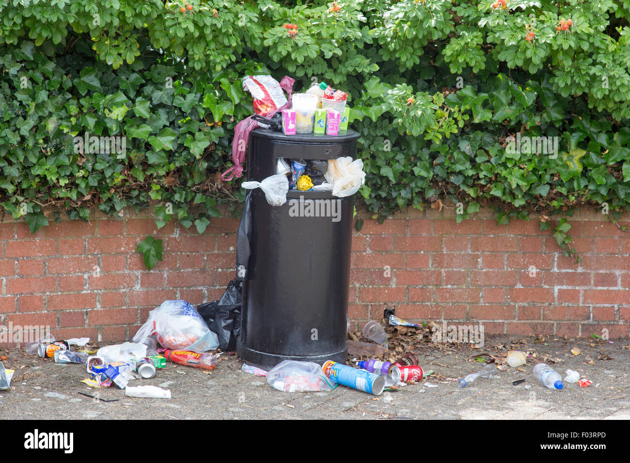 Overfull rubbish bin, England, UK Stock Photo