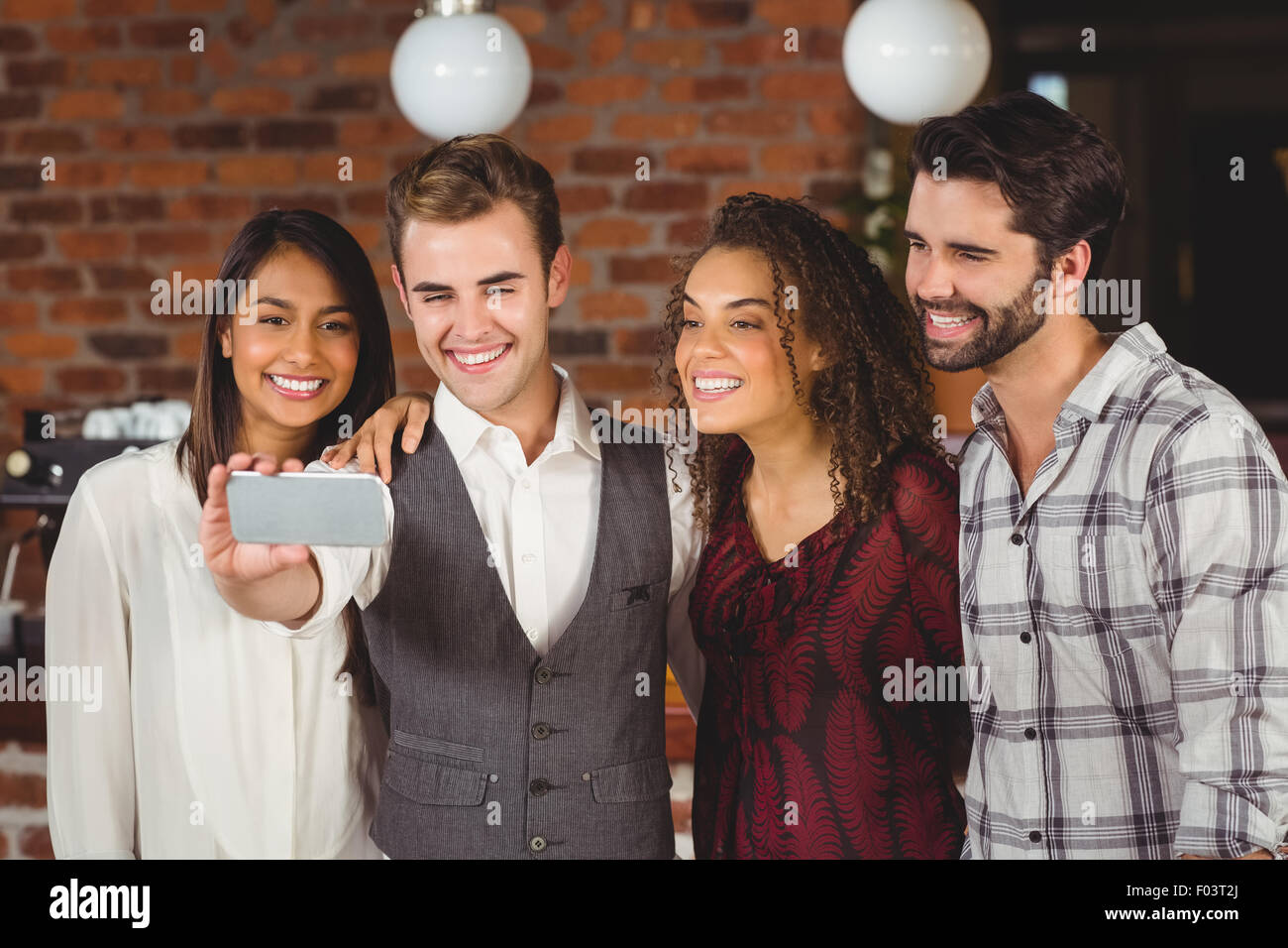 Smiling friends taking a selfie together Stock Photo
