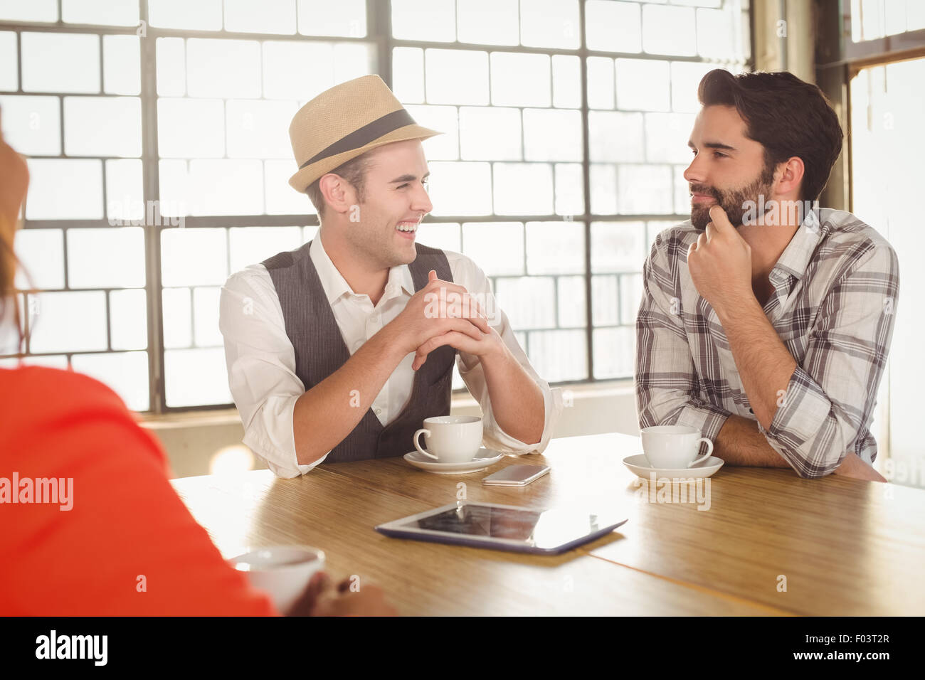 Smiling friends talking and having coffee together Stock Photo