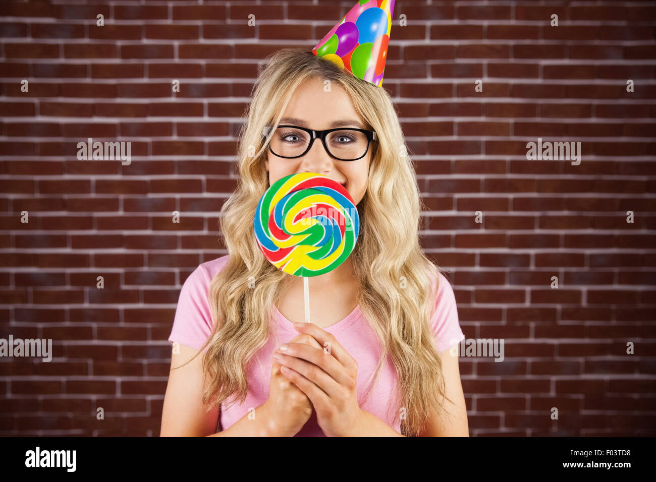 A beautiful hipster holding a giant lollipop Stock Photo