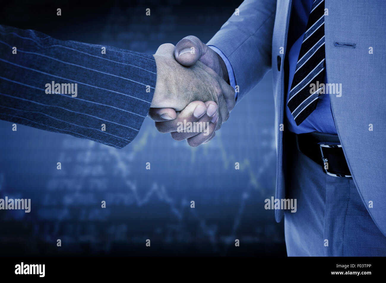Composite image of businessman shaking hands with a co worker Stock Photo