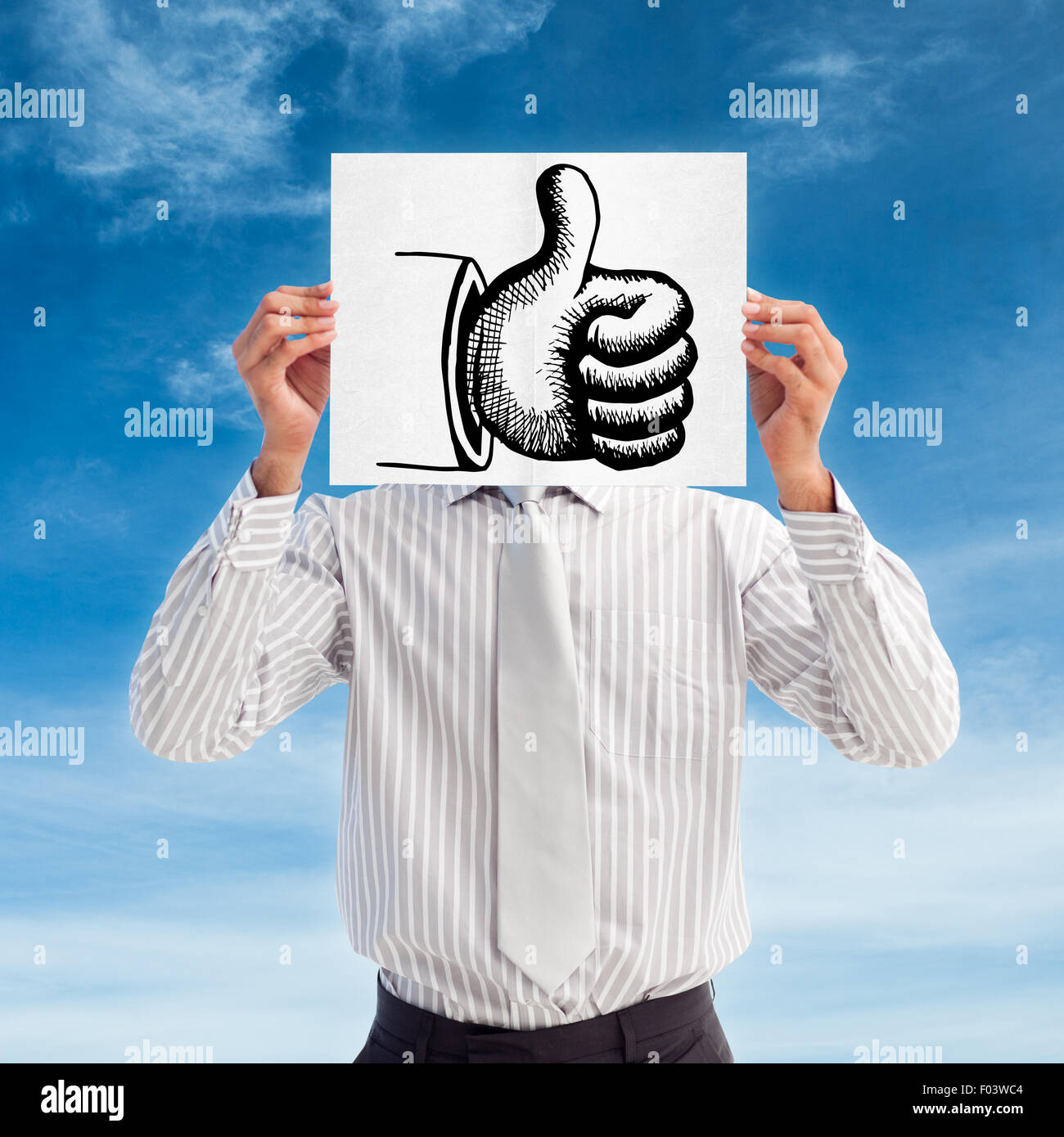 Composite image of businessman holding a white card covering his face Stock Photo